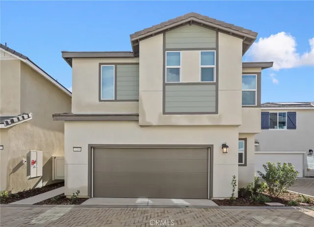 a front view of a house with garage