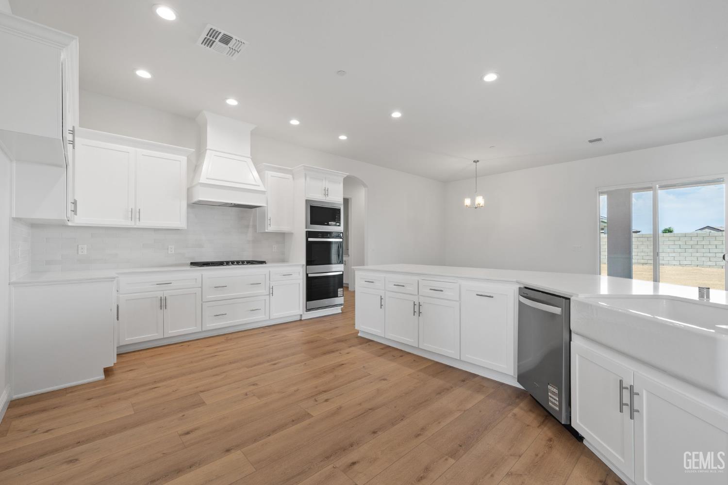 Undisclosed Address Bakersfield, CA 93314 - Photo 24 of 55 a large kitchen with granite countertop a large counter top and stainless steel appliances