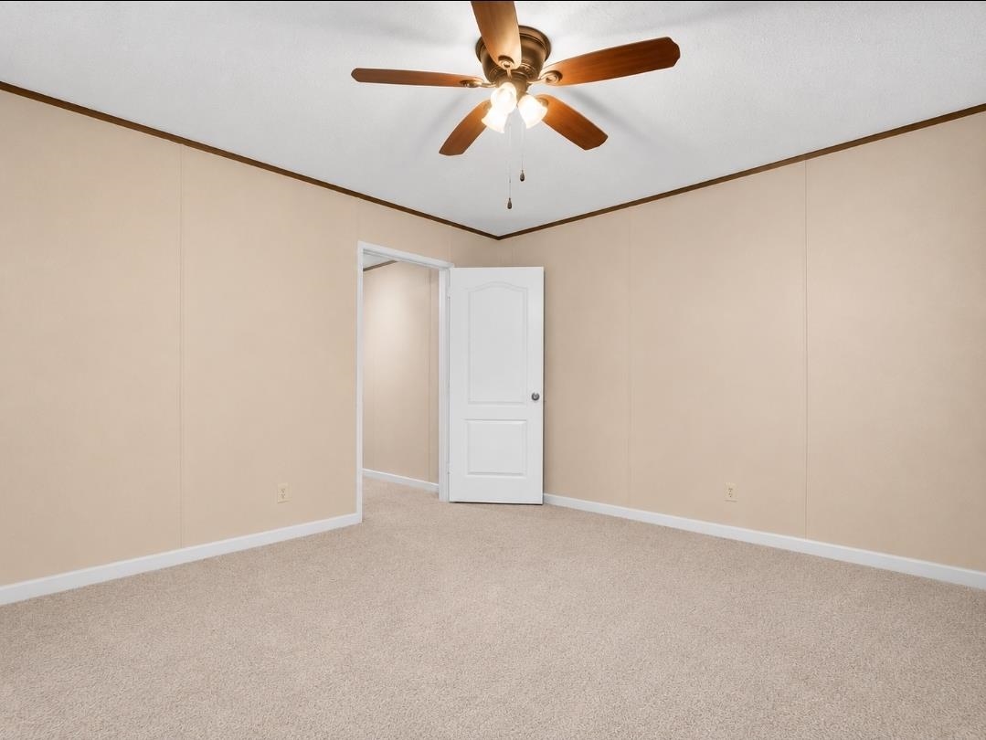 3779 Dancyville Road Stanton, TN 38069 - Photo 7 of 22 Carpeted room featuring light beige walls, white baseboards, and a ceiling fan with integrated lighting