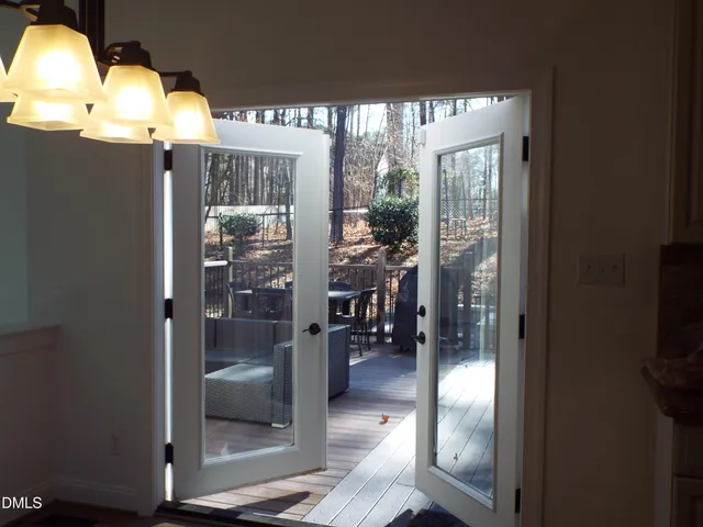 an empty room with windows and fireplace