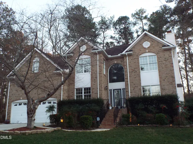 an aerial view of a house with table and chairs