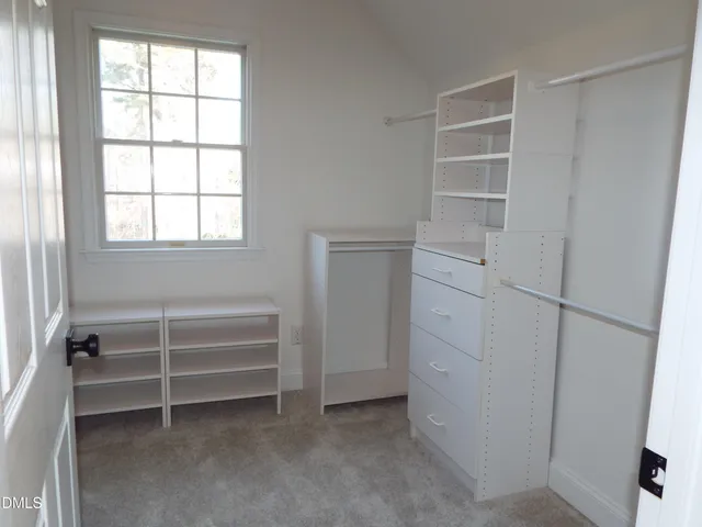 a view of a backyard with wooden fence