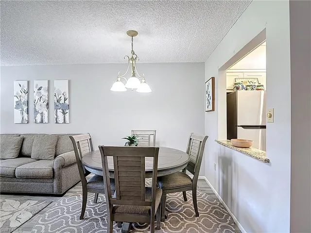 a view of a dining room with furniture and chandelier