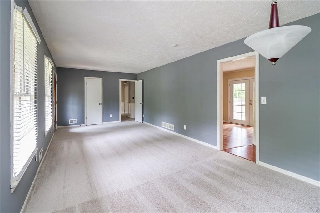 1291 Stephens Street Southwest Lilburn, GA 30047 - Photo 10 of 22 a view of an empty room with glass door and windows