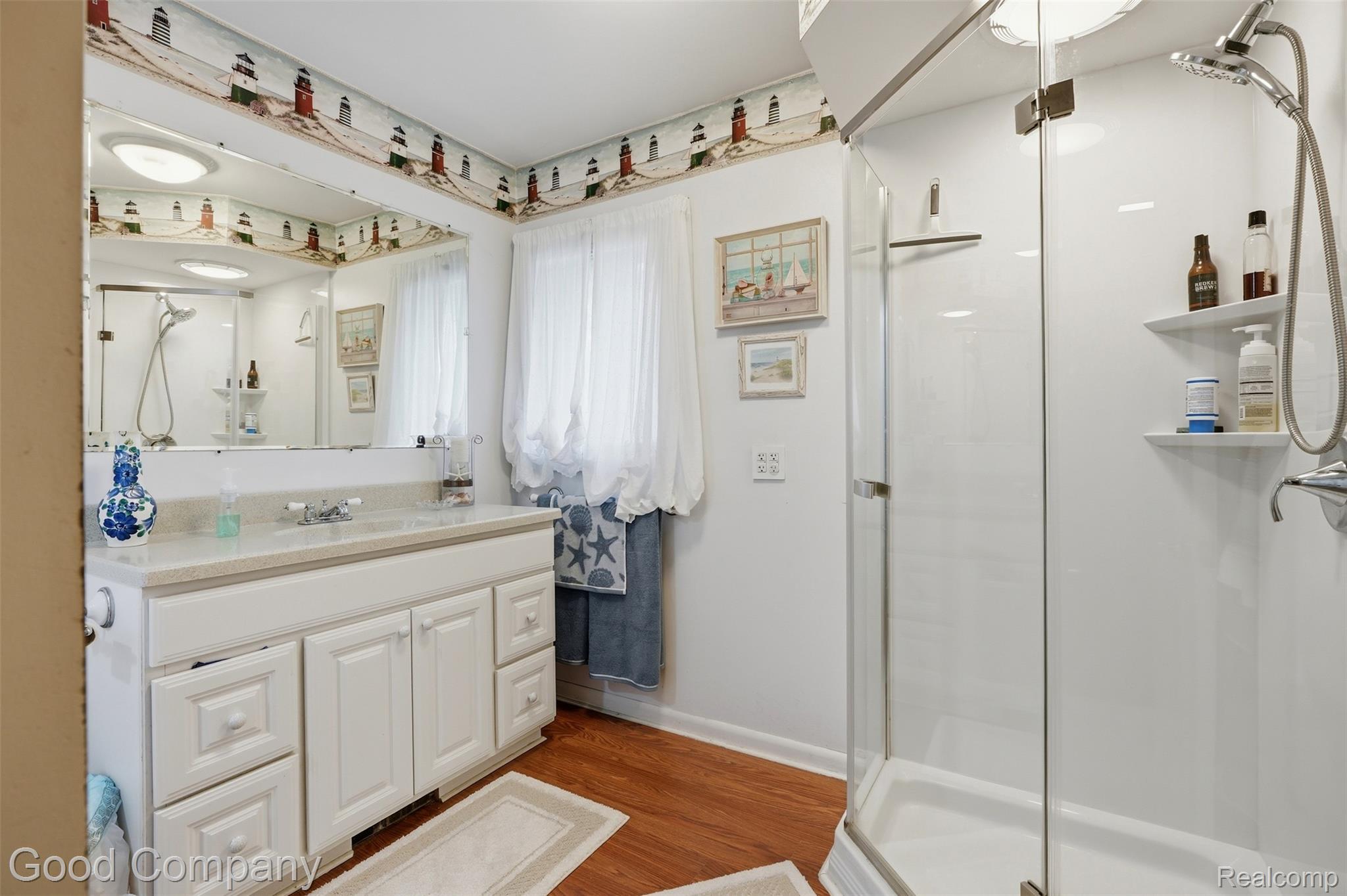 3615 Hazelton Avenue Rochester, MI 48307 - Photo 17 of 56 Full bathroom featuring a glass-enclosed shower, a white vanity with double cabinet storage and multiple drawers, a white countertop, and wood-finish flooring