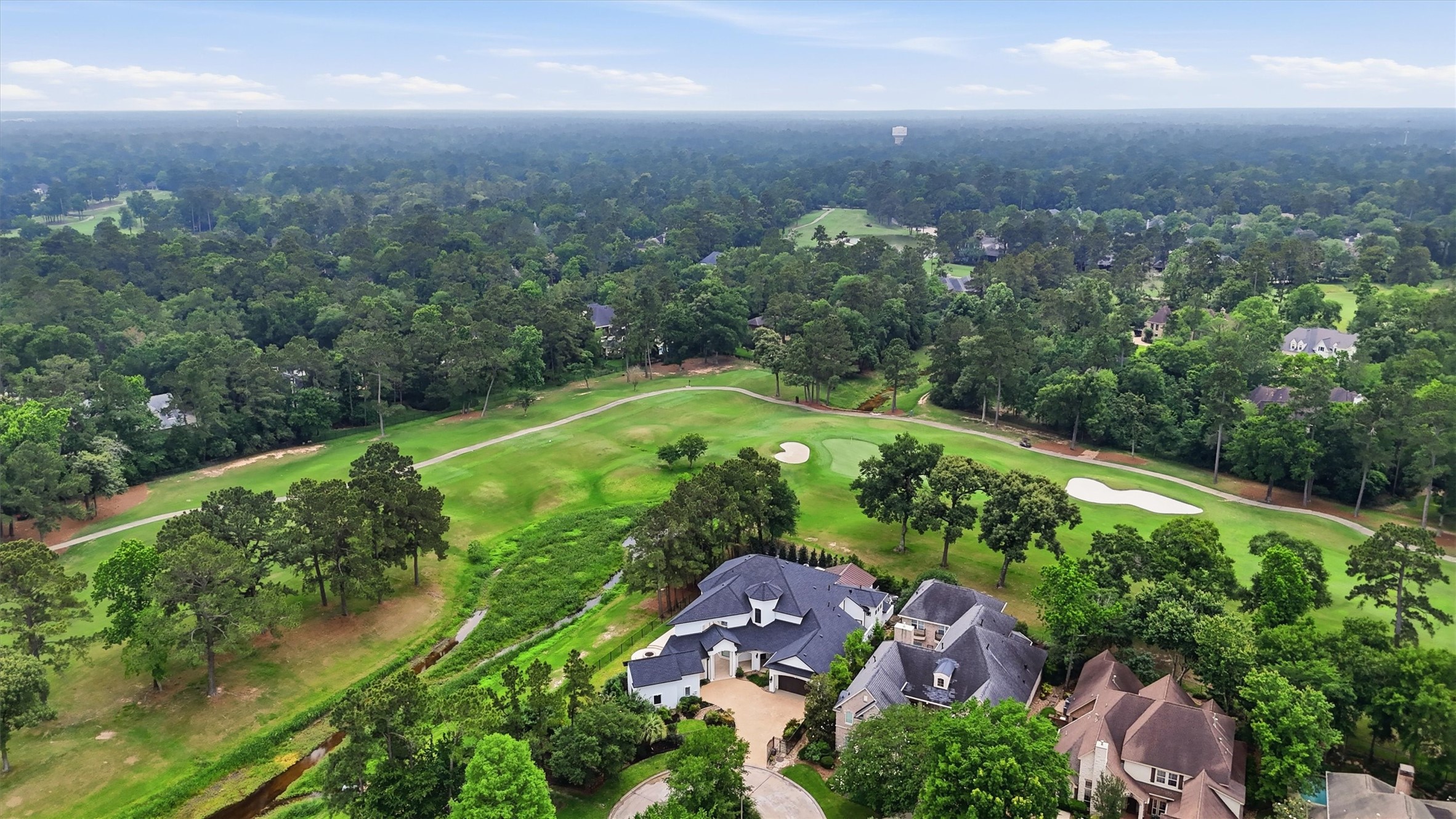 70 Quail Rock Place The Woodlands, TX 77381 - Photo 43 of 46 an aerial view of green landscape with trees and houses
