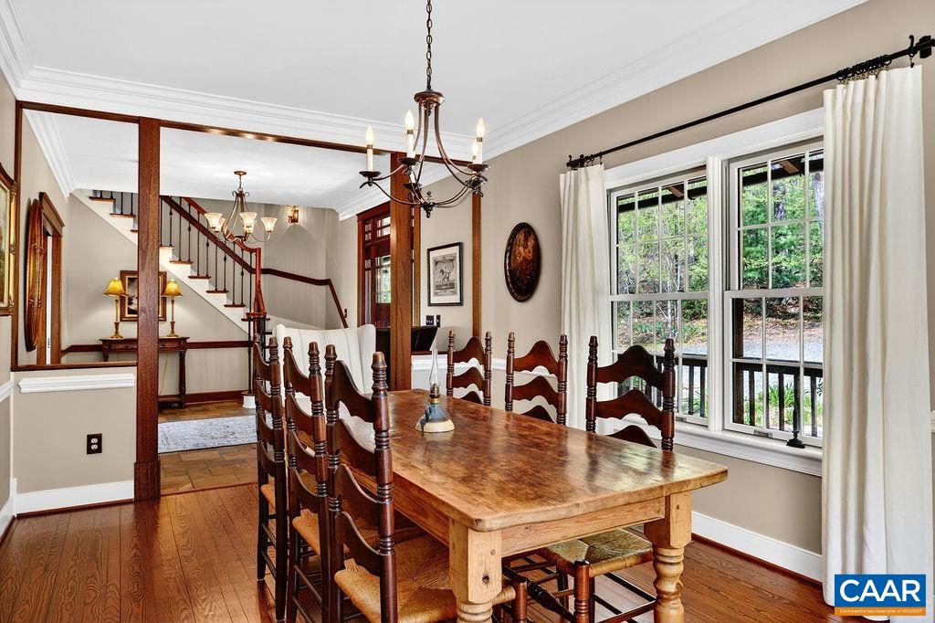 1059 Bryant Mountain Road Roseland, VA 22967 - Photo 14 of 58 a dining room with wooden floor a chandelier a wooden table and chairs