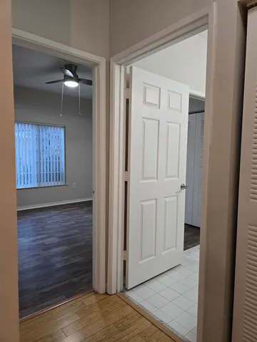 a view of empty room with wooden floor