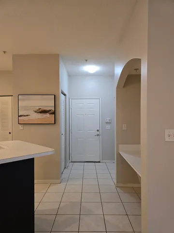 a kitchen with a refrigerator and a stove top oven