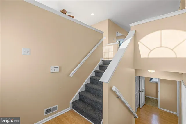 a view of entryway and hall with wooden floor