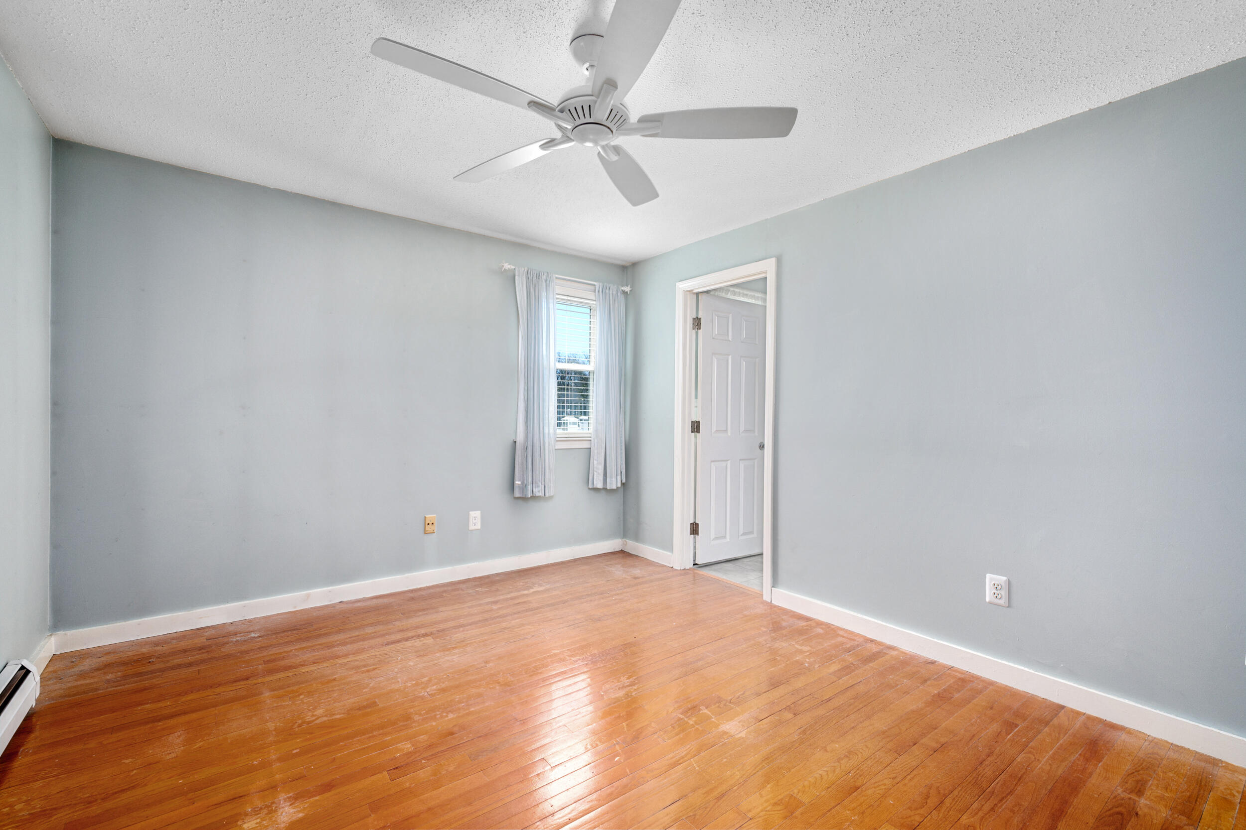 136 Sheaffer Road Centerville, MA 02632 - Photo 17 of 44 a view of a big room with wooden floor and a ceiling fan