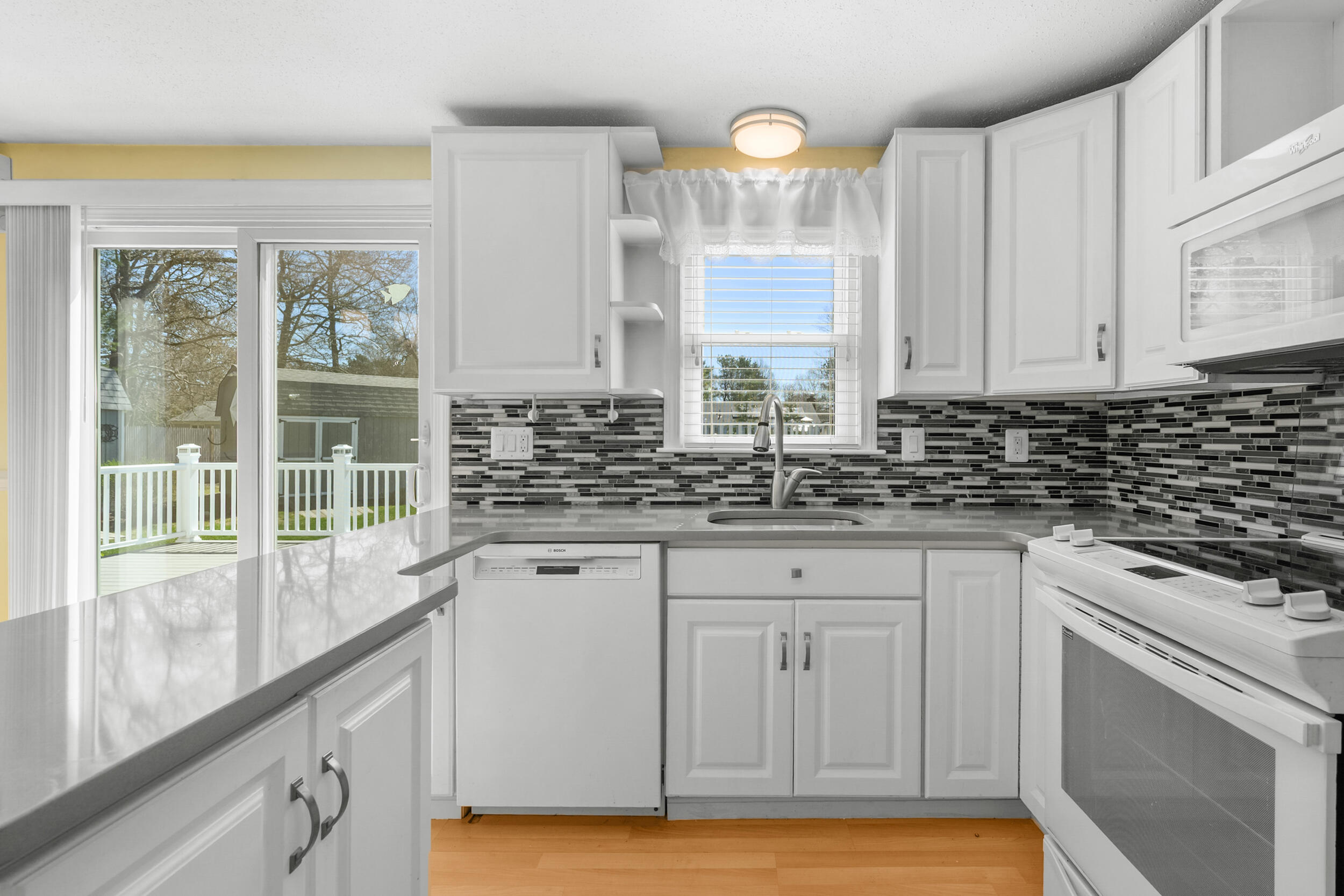136 Sheaffer Road Centerville, MA 02632 - Photo 5 of 44 a view of a kitchen with granite countertop a sink and a window