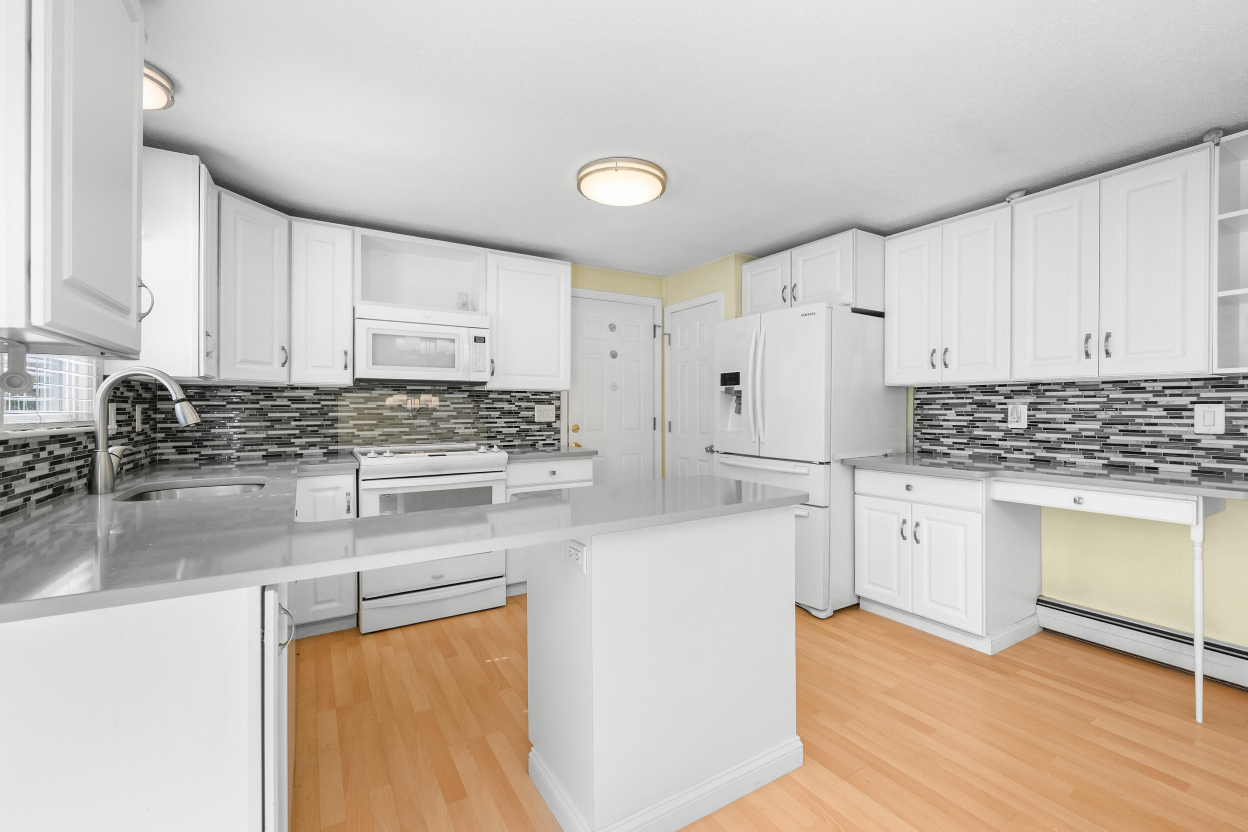 136 Sheaffer Road Centerville, MA 02632 - Photo 7 of 44 a kitchen with stainless steel appliances granite countertop a stove a sink and white cabinets