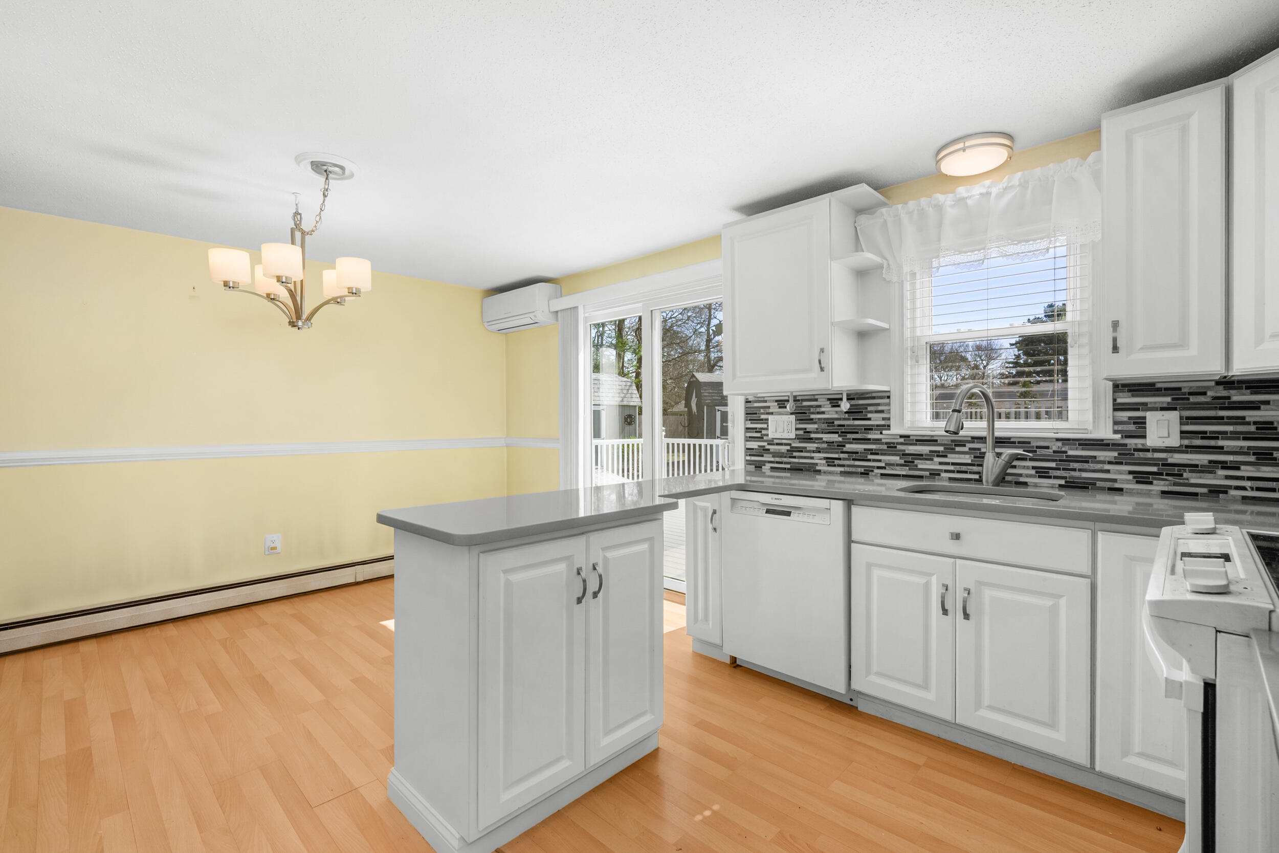 136 Sheaffer Road Centerville, MA 02632 - Photo 10 of 44 a kitchen with granite countertop white cabinets and a dishwasher