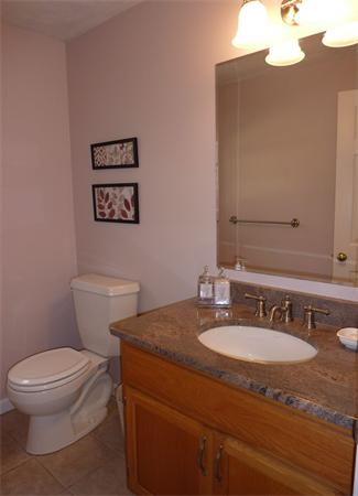 8 Nehemiah Road Shirley, MA 01464 - Photo 12 of 19 a bathroom with a granite countertop toilet sink and mirror