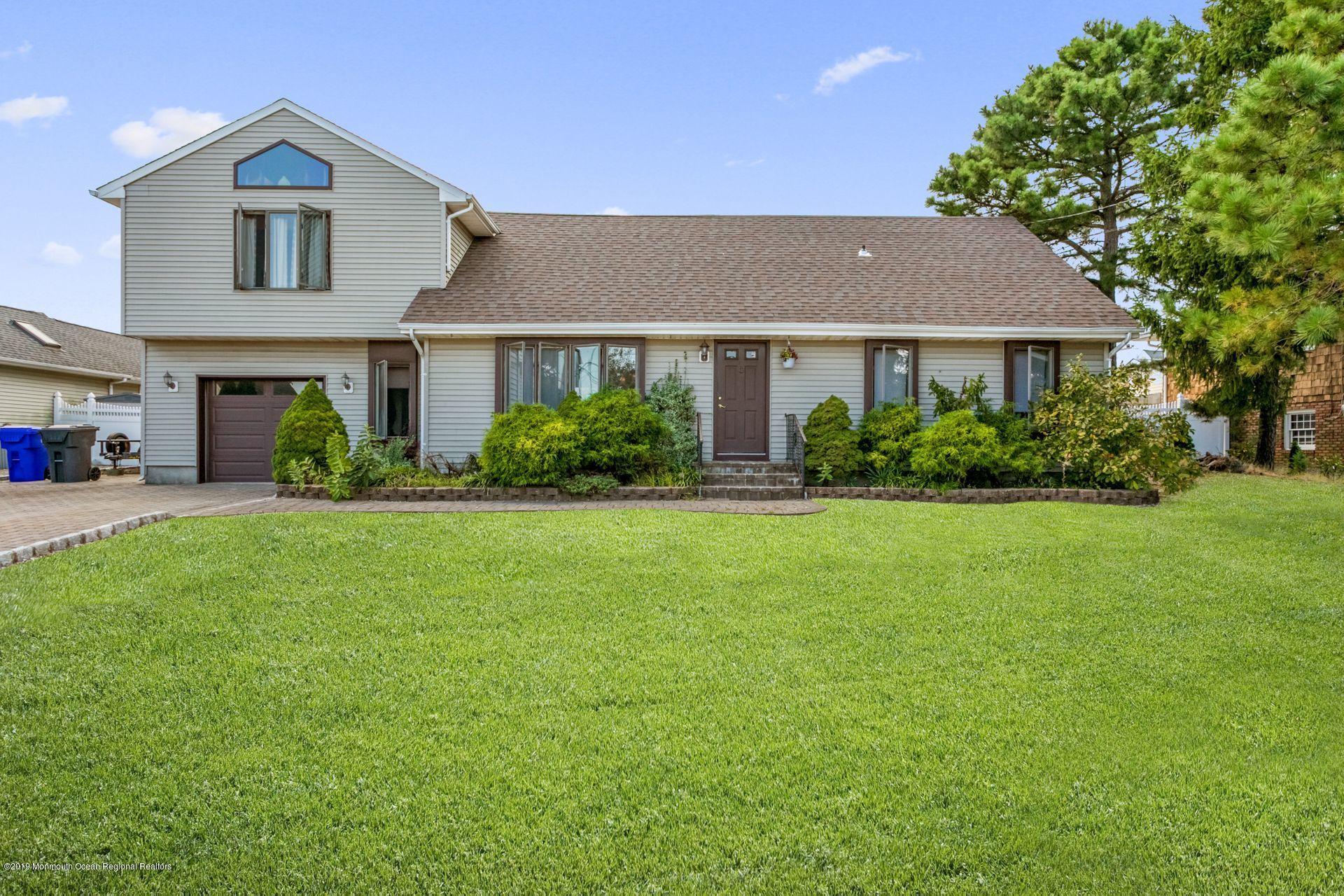 132 Mizzen Road Brick, NJ 08723 - Photo 2 of 41 a front view of a house with a yard and garage