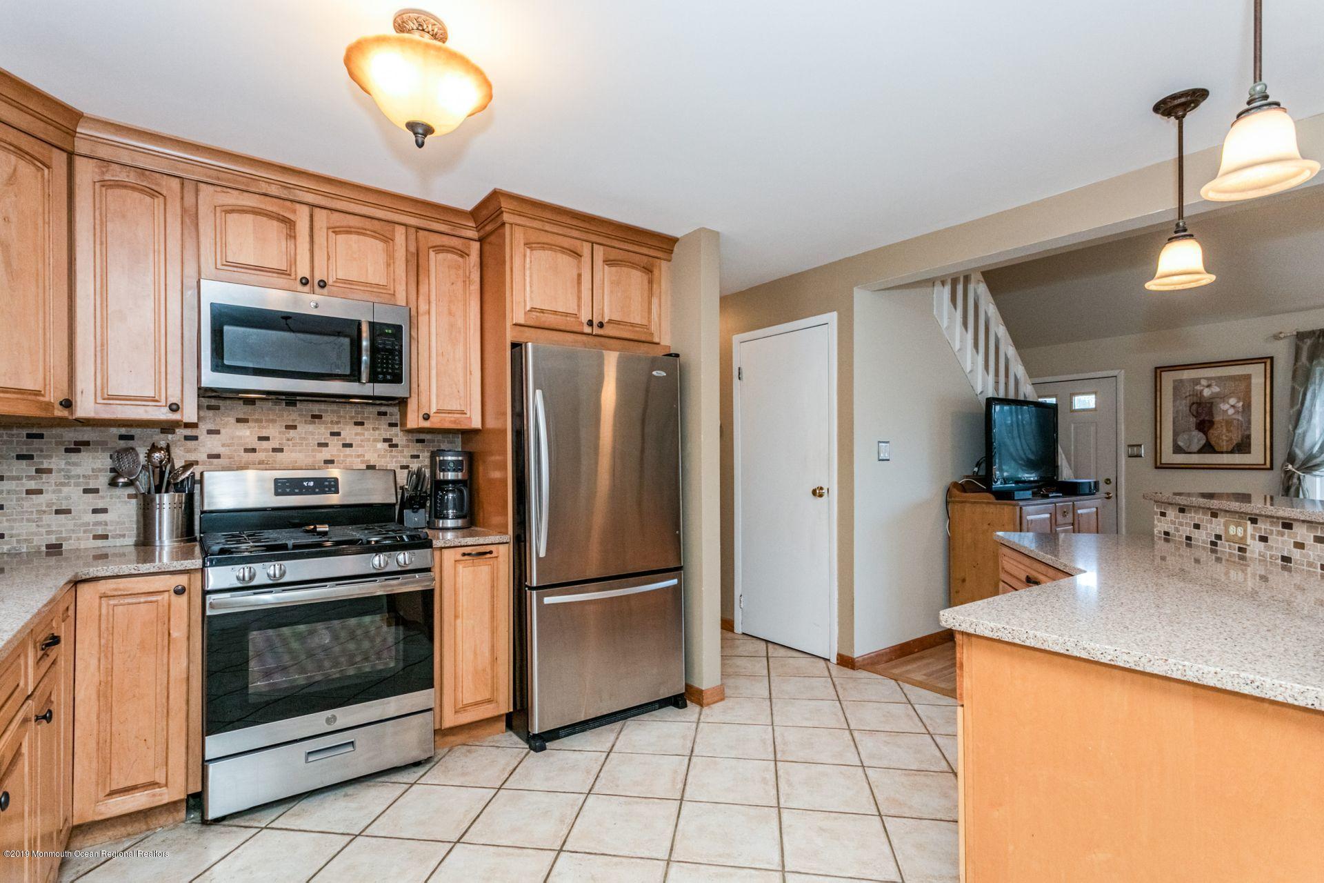 132 Mizzen Road Brick, NJ 08723 - Photo 12 of 41 a kitchen with granite countertop a refrigerator a stove top oven a sink and dishwasher