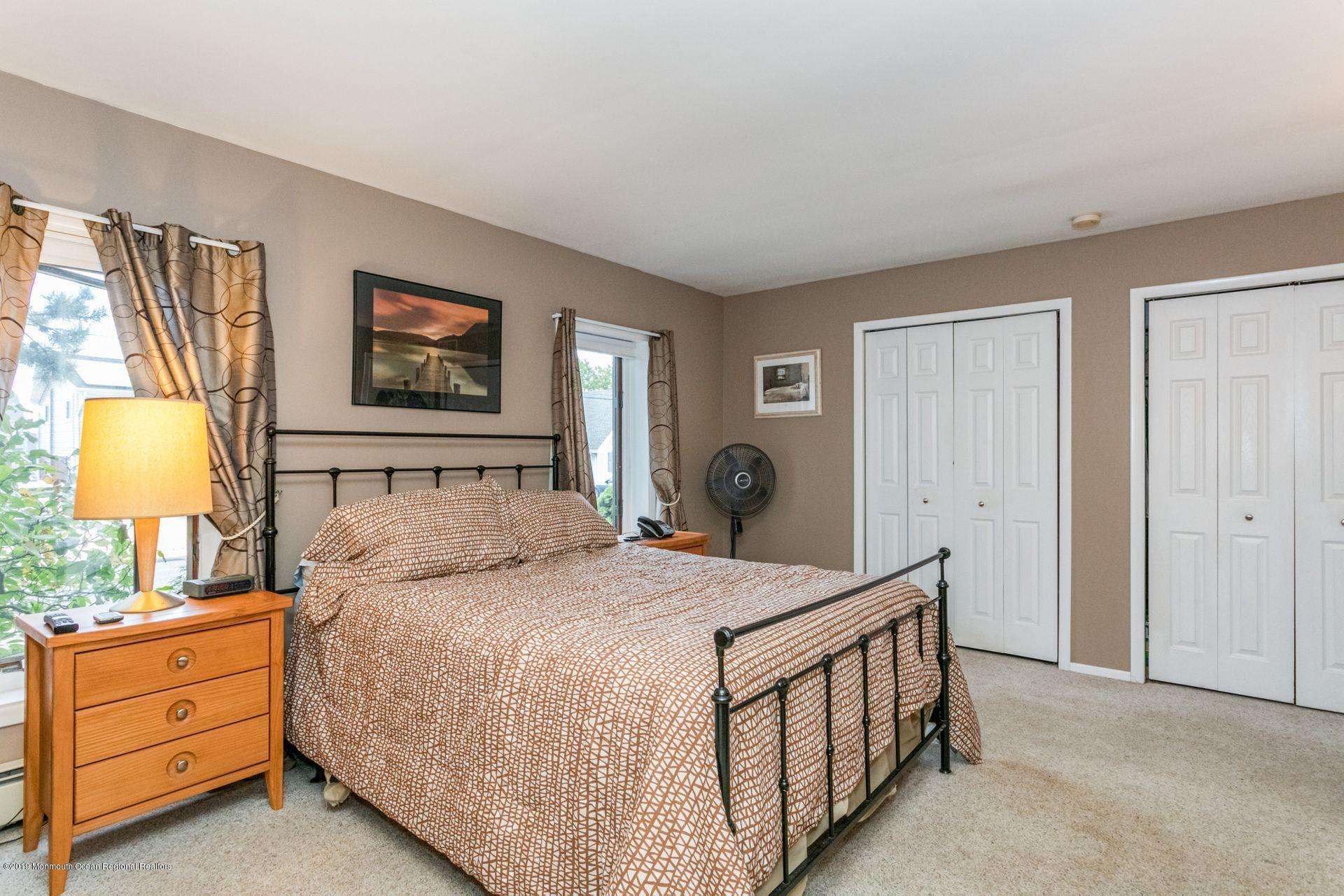 132 Mizzen Road Brick, NJ 08723 - Photo 15 of 41 a bedroom with a bed and a lamp on dresser