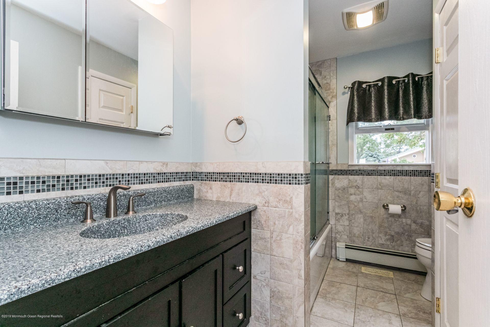 132 Mizzen Road Brick, NJ 08723 - Photo 16 of 41 a bathroom with a sink and a mirror