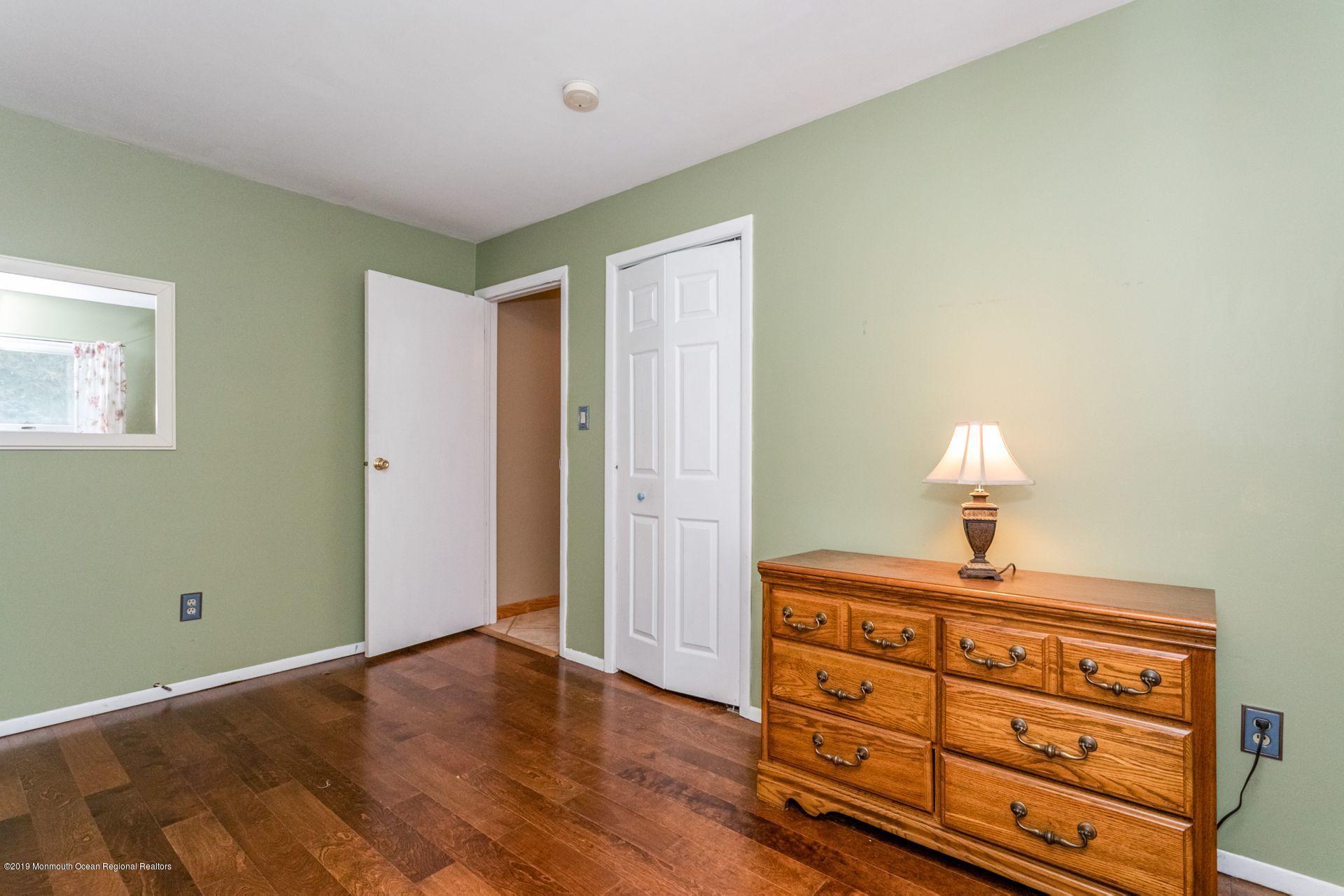 132 Mizzen Road Brick, NJ 08723 - Photo 18 of 41 a bedroom with a bed and a lamp on the dresser