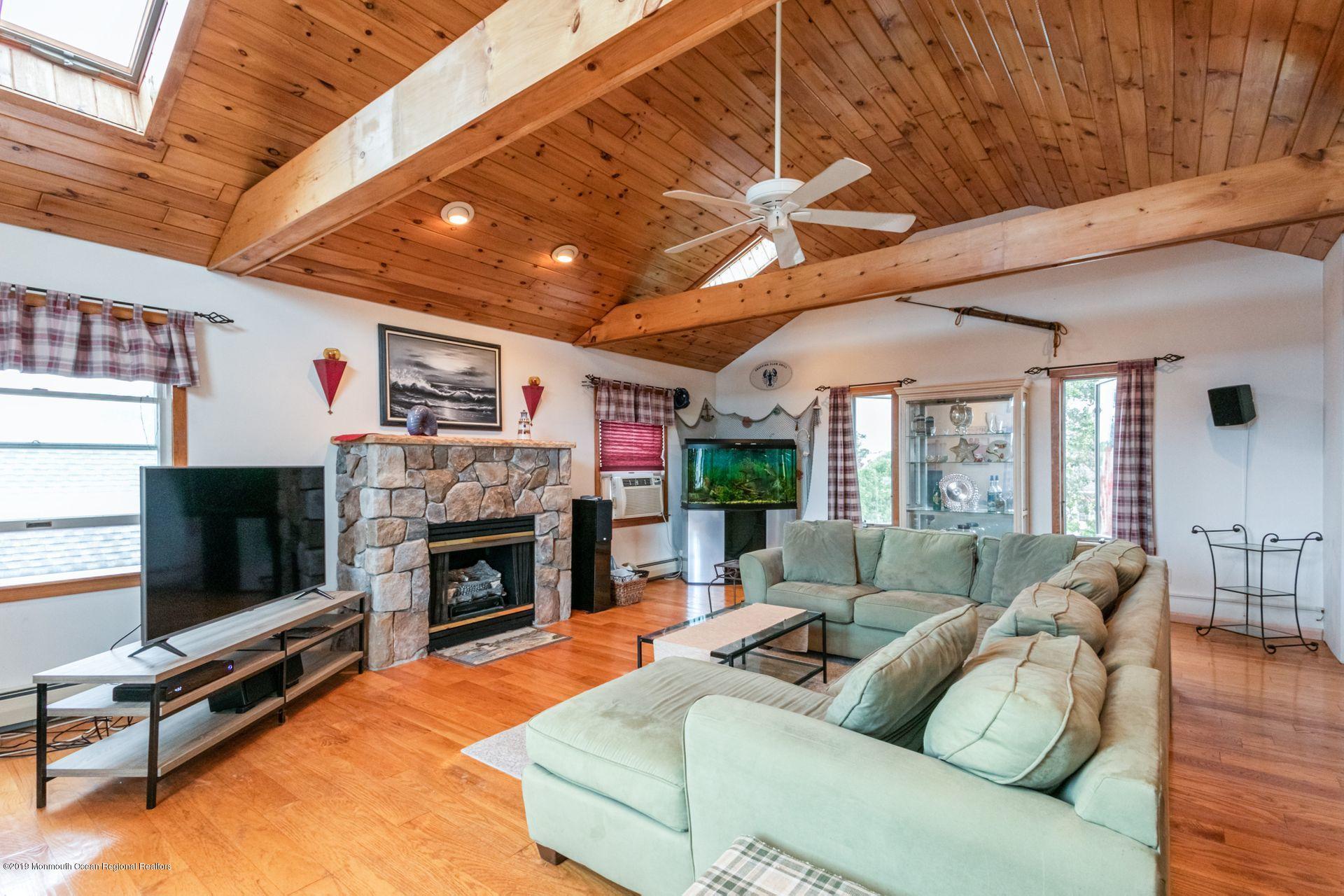 132 Mizzen Road Brick, NJ 08723 - Photo 26 of 41 a living room with furniture a flat screen tv and a fireplace