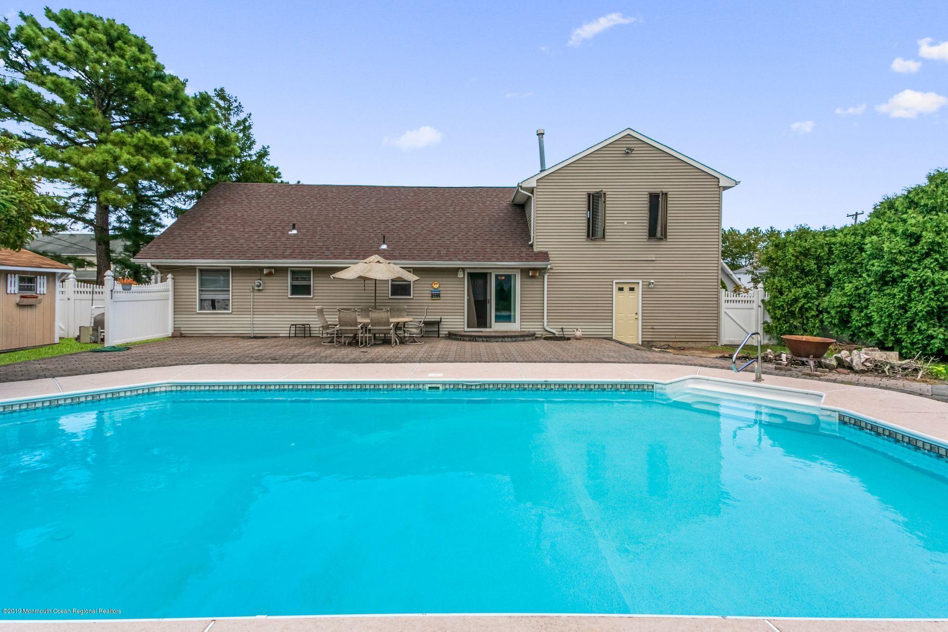 132 Mizzen Road Brick, NJ 08723 - Photo 27 of 41 a front view of a house with swimming pool and a yard