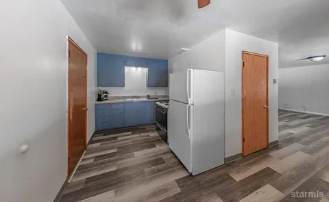 a kitchen with sink stove and cabinets