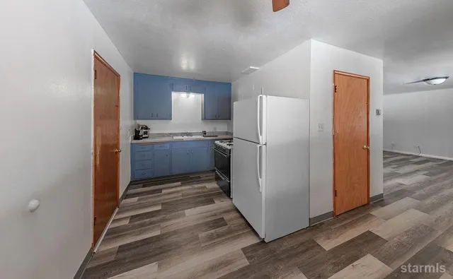 a kitchen with sink stove and cabinets