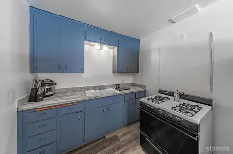 a view of a room with wooden floor and fan