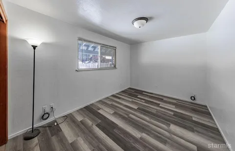 a view of a room with wooden floor and windows