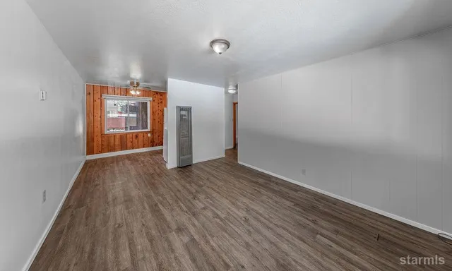 a view of a kitchen with a sink and dishwasher a refrigerator with wooden floor