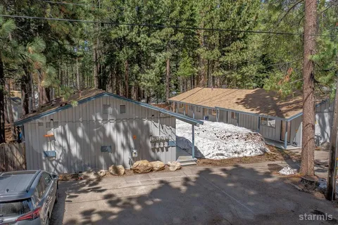 a view of a wooden deck and a backyard