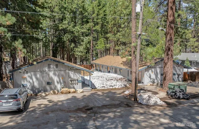 an aerial view of a residential house with a yard
