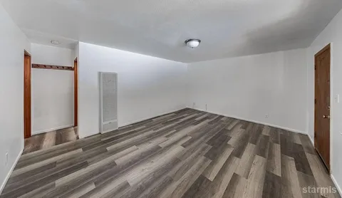 a view of a room with wooden floor