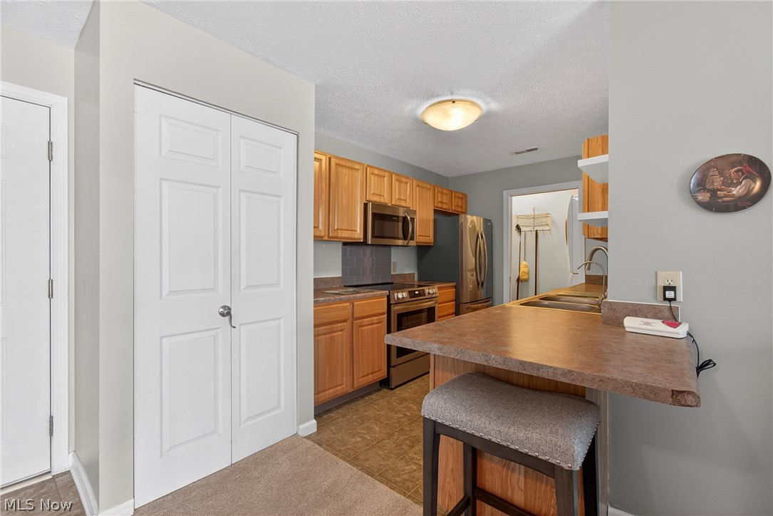 4703 Hills And Dales Road Northwest Canton, OH 44708 - Photo 10 of 25 breakfast bar in open kitchen