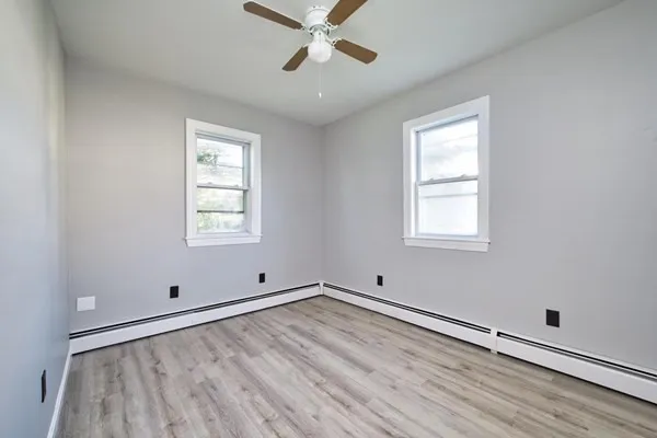 wooden floor in an empty room with a window