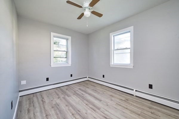 54 Grinnell Street, Unit 1 Fall River, MA 02721 - Photo 4 of 7 wooden floor in an empty room with a window