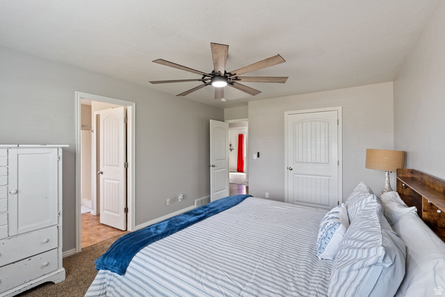 444 South Saddle Road Grantsville, UT 84029 - Photo 12 of 33 Bedroom with ceiling fan, carpet floors, a closet, and ensuite bathroom
