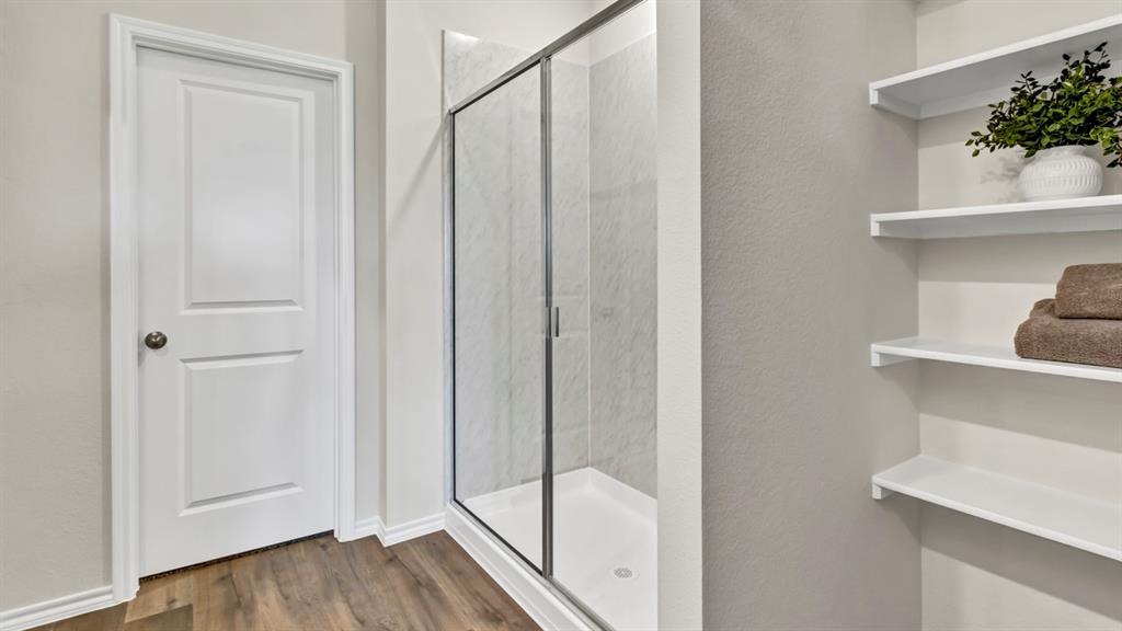124 Pheasant Run Road Terrell, TX 75160 - Photo 26 of 35 Walk-in shower with clear glass enclosure and tile surround
