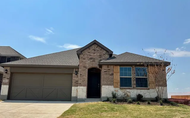 a front view of a house with yard