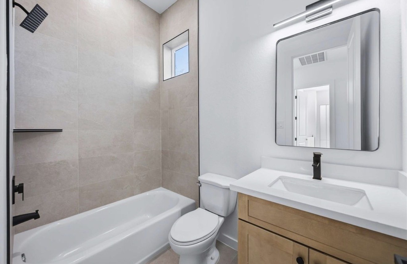 3923 Aledo Street, Unit B Houston, TX 77051 - Photo 11 of 12 a bathroom with a sink a toilet and shower