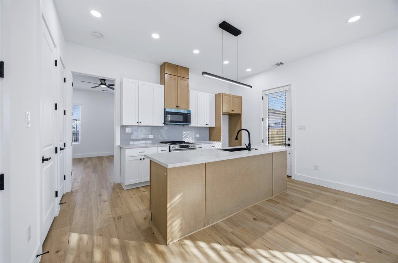 3923 Aledo Street, Unit B Houston, TX 77051 - Photo 4 of 12 a large kitchen with a sink stainless steel appliances and cabinets