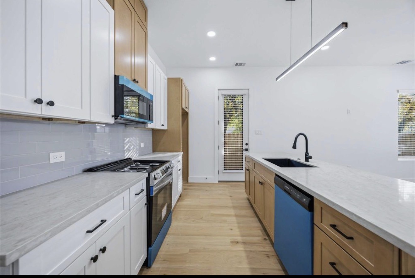 3923 Aledo Street, Unit B Houston, TX 77051 - Photo 6 of 12 a kitchen with stainless steel appliances granite countertop a stove a sink and a refrigerator