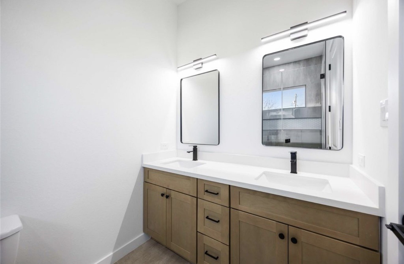 3923 Aledo Street, Unit B Houston, TX 77051 - Photo 8 of 12 a bathroom with a toilet sink and mirror