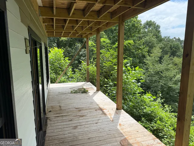 a view of a hallway with wooden walls and stairs