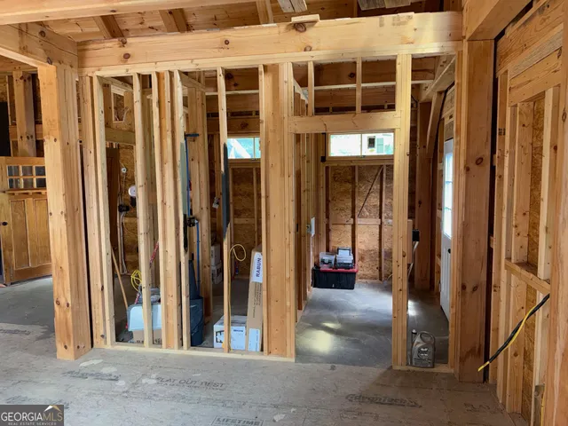 a view of a hallway with furniture and a window