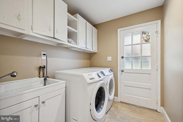 11810 Coldstream Drive Potomac, MD 20854 - Photo 22 of 30 a utility room with sink dryer and washer