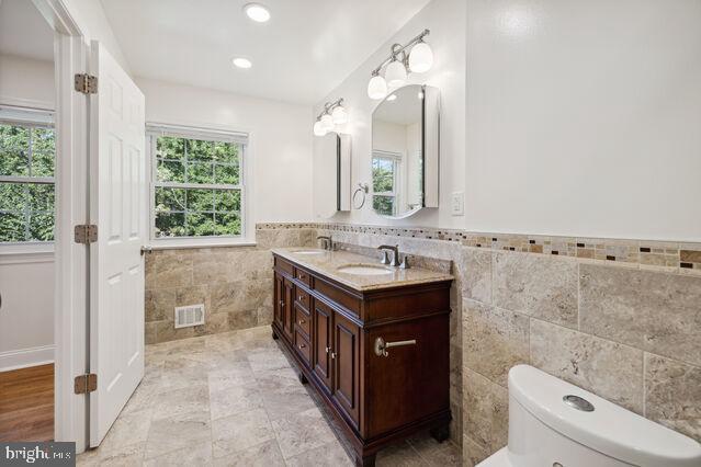 11810 Coldstream Drive Potomac, MD 20854 - Photo 23 of 30 a bathroom with a sink a toilet and mirror