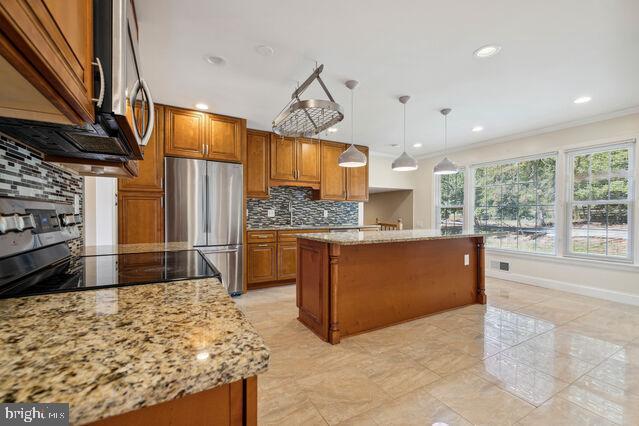11810 Coldstream Drive Potomac, MD 20854 - Photo 9 of 30 a kitchen with stainless steel appliances kitchen island granite countertop a refrigerator and stove