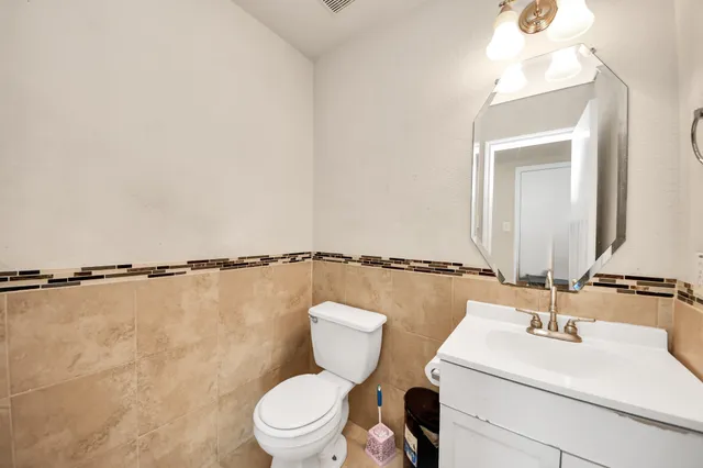a bathroom with a double vanity sink toilet and shower